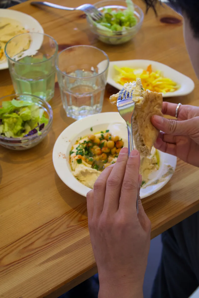Guest eating hummus with pita bread