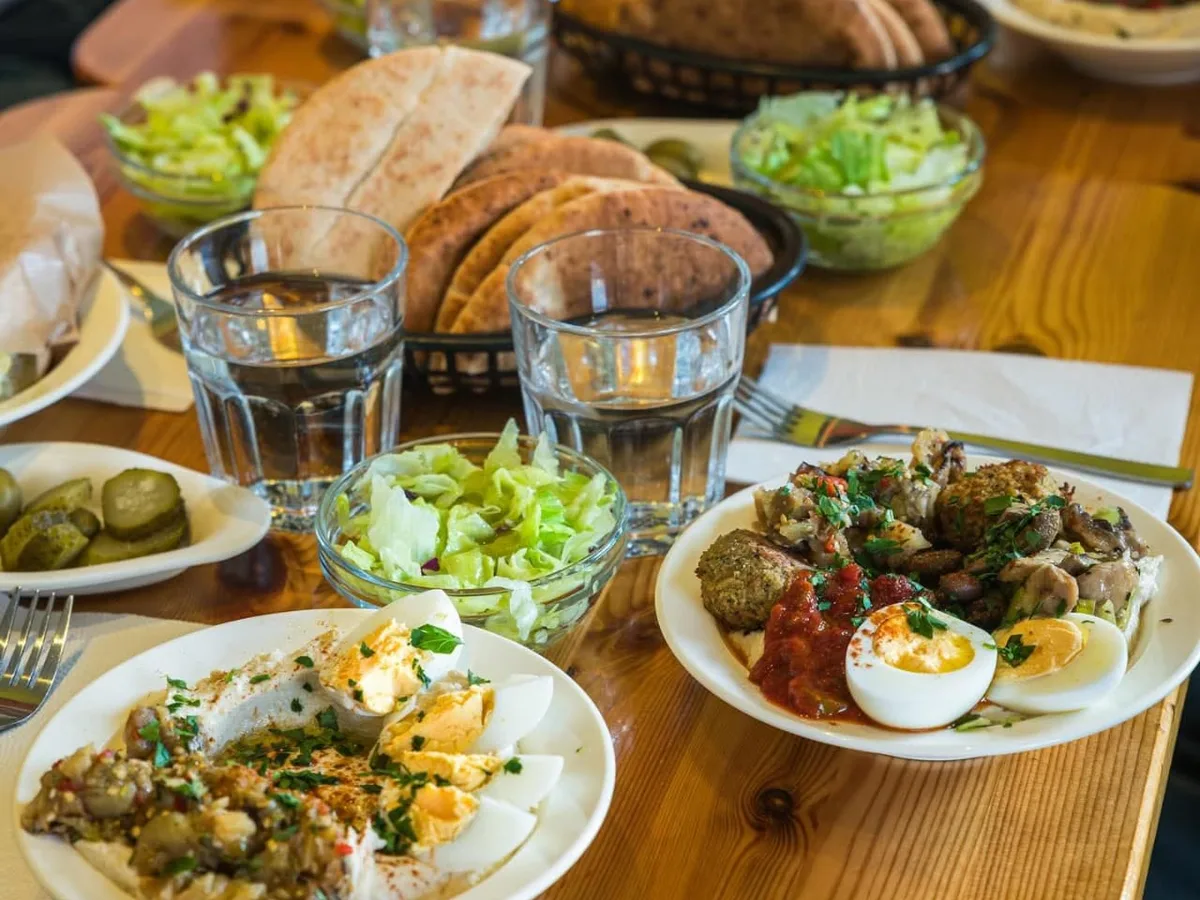 Table set with hummus, falafel, egg and sides
